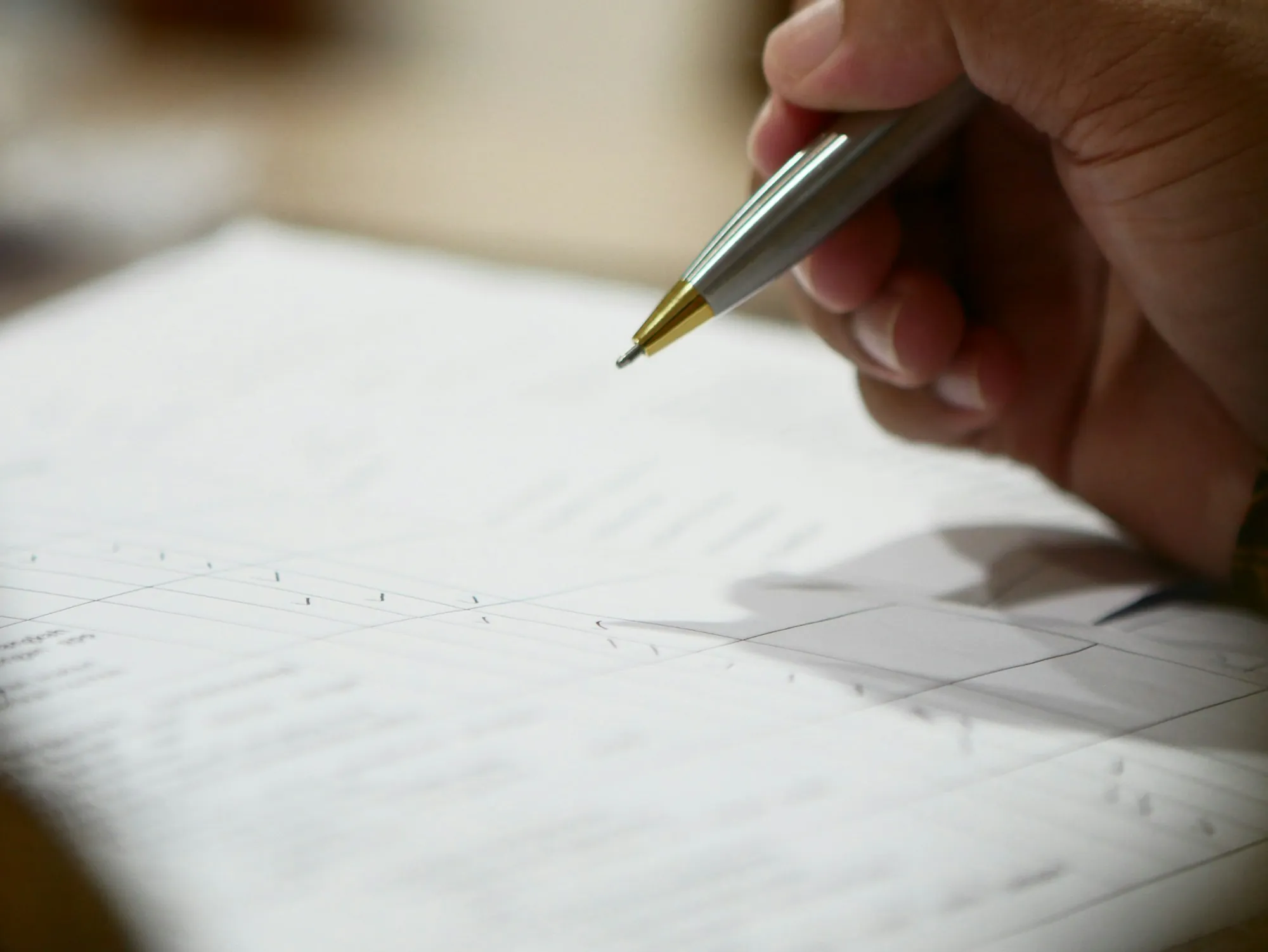 Pen tip over a sheet of paper